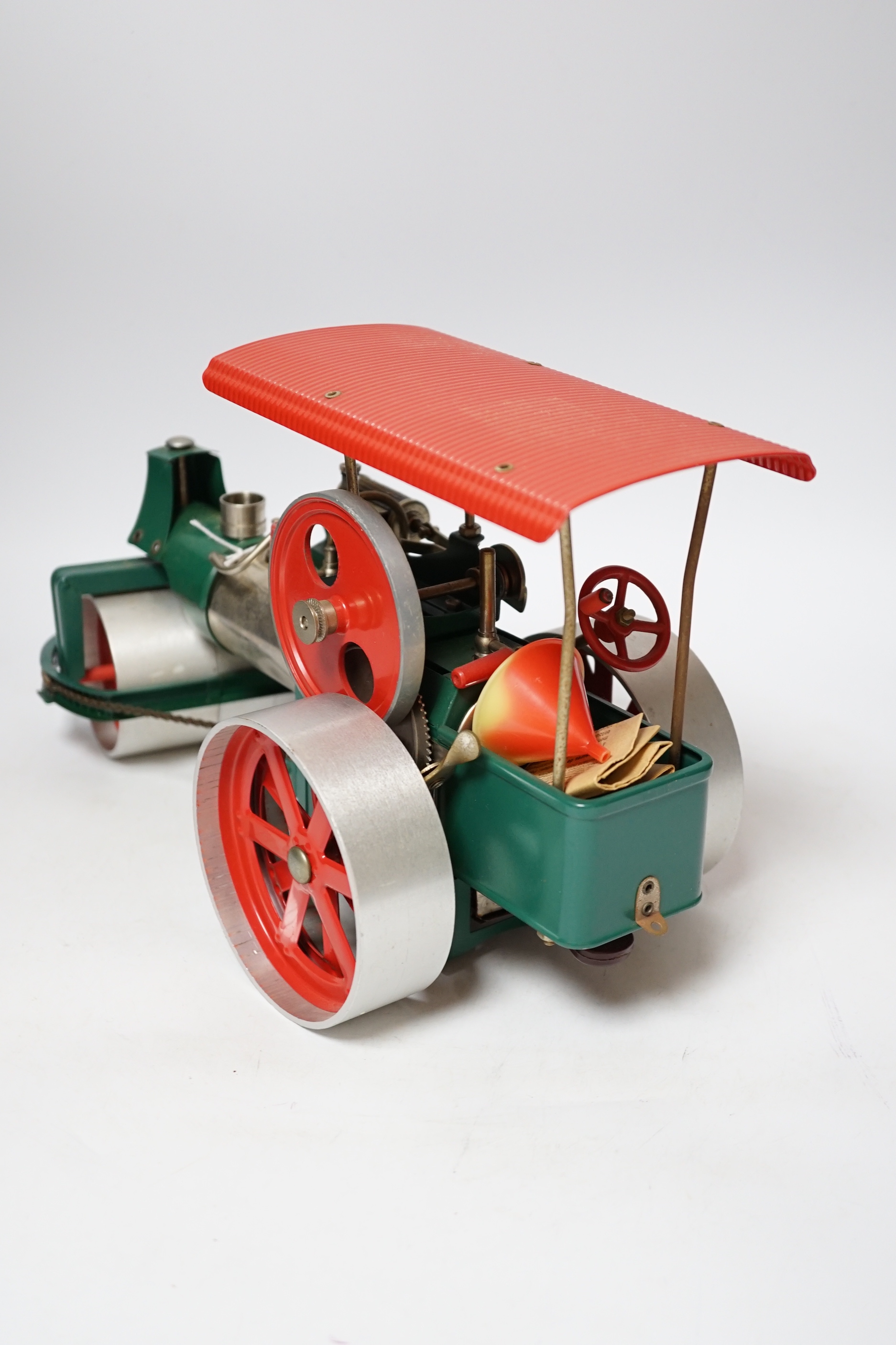 A Wilesco live steam tinplate and aluminium model Road Roller, missing its chimney